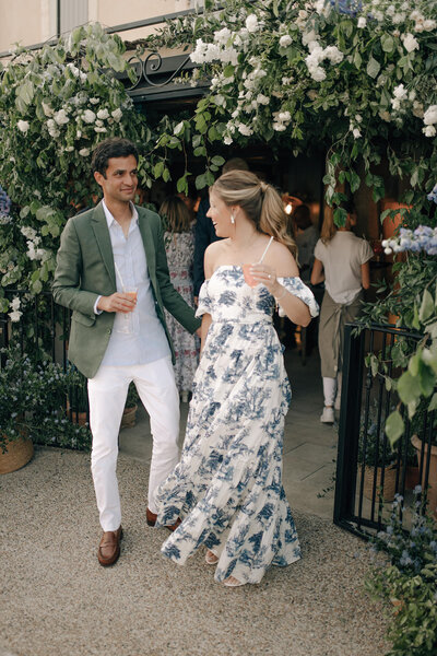 Blue and white toile off the shoulder dress next to a sage green suit jacket for an Italian themed wedding Welcome Dinner in the Provencal village of Gordes, France