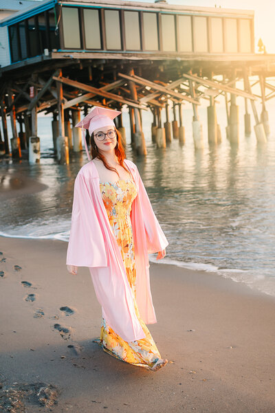 orlando high school senior picture of a girl in white top and jeans on the beach