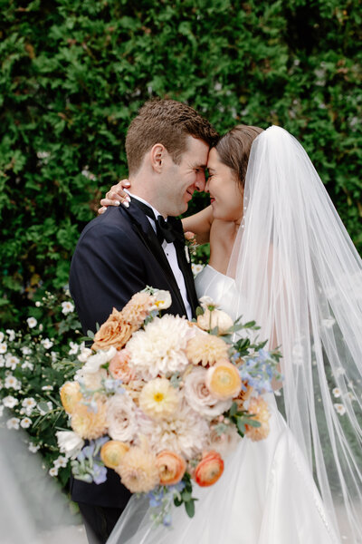 Bride and groom kiss on a Chicago median as traffic whirs by after their wedding