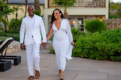 Bride and groom holding hands and smiling during golden hour, captured in a romantic outdoor setting by Indianapolis wedding videographer
