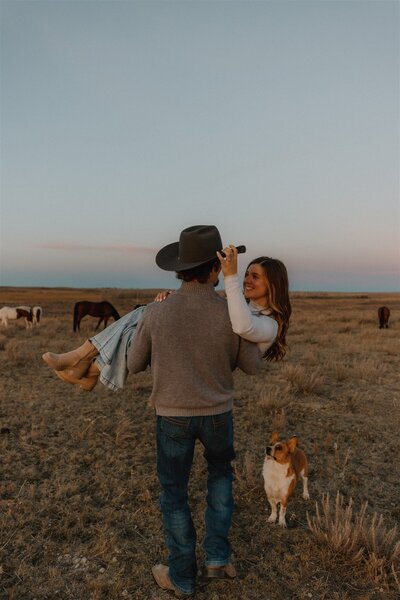 Outdoor portrait of a Wyoming-based photographer, standing in a scenic natural setting with soft lighting and a relaxed pose.