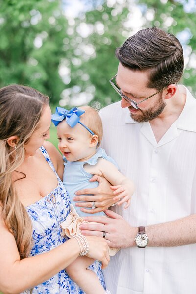 Mom and dad posing with baby daughter at Opelika family session