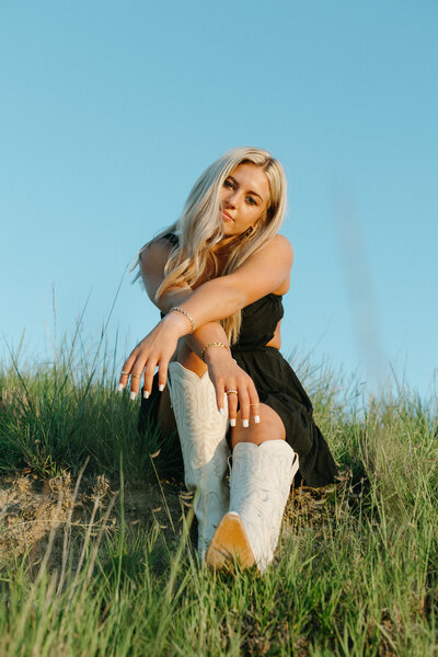bride laughing at rodeo with cowboy boots on