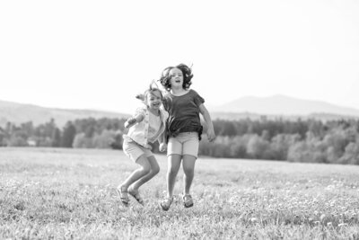 Daughters jumping in a field | Family Photos