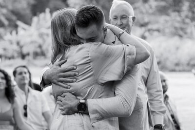 A wedding participant hugging their parent during their wedding ceremony 