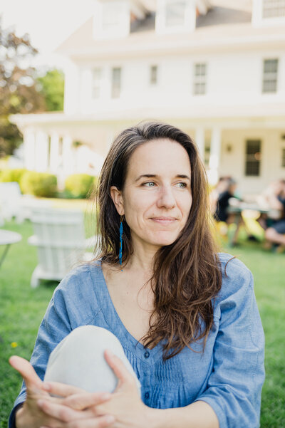 Relaxed lifestyle portrait of family photographer Rebecca Bloomfield in the Hudson Valley, with a soft, candid expression