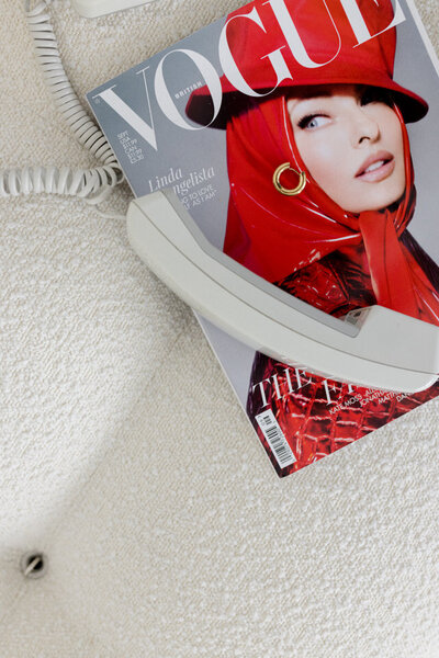 Flat Lay, Detail photo of a vintage phone on a vintage Vogue Magazine