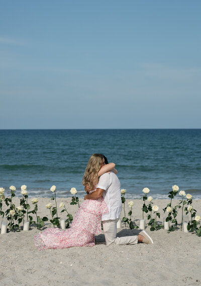 Couple hugging on the beach taken by Shelby Ann Photos, florida engagement photographers