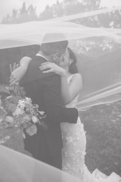 Couple sitting on the ground hugging and smiling