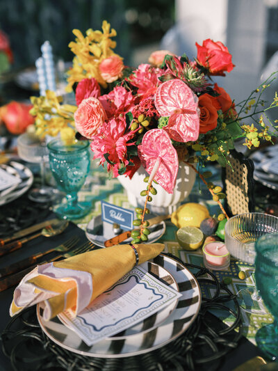 An intricate and fun table setting at a DMV wedding reception taking place at a luxury waterfront venue