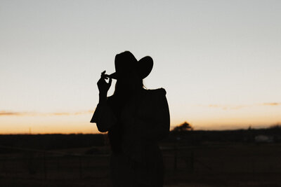 Silhouette of a cowgirl at sunset in Waco Texas