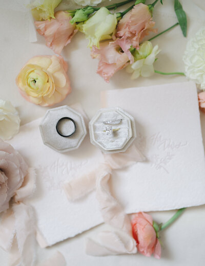 Pink, yellow, and cream colored wedding day details and vow books