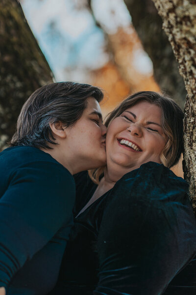 A person kisses their new spouse on the cheek
