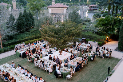 Bride embraces groom on terrace