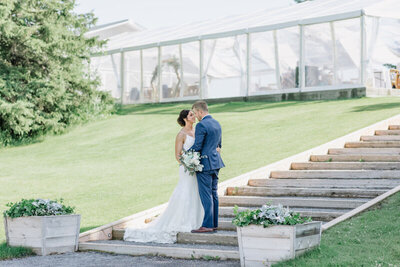 Tented reception with eucalyptus and baby blue accents at Pine & Pond, a natural picturesque wedding venue in Ponoka, AB, featured on the Brontë Bride Vendor Guide.