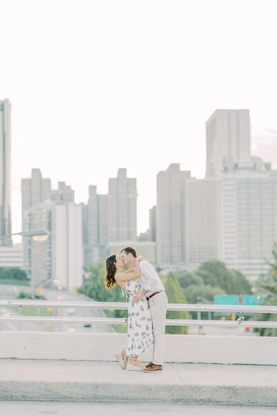 Man kissing woman in front of  skyline