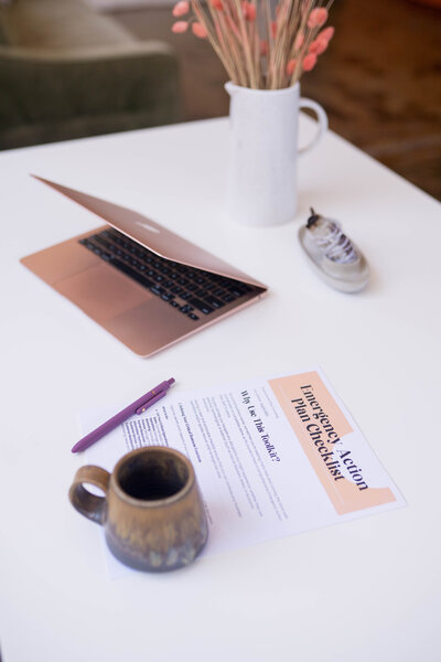 laptop computer and a printout of BCWise resources 