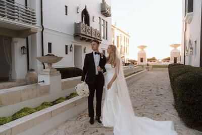 bride and groom posed elegantly outside private home