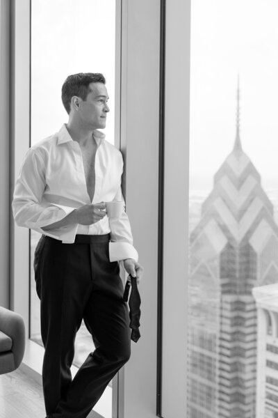 Groom getting ready in a luxury high-rise hotel in downtown Philadelphia