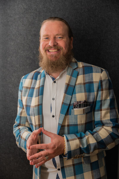 Jarrett Green, Co-Founder of NKB Consultancy wearing a blue and tan blazer