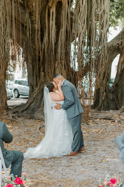 An intimate elopement under the majestic banyan trees at North Straub Park in St. Pete, offering a blend of natural beauty and urban charm.