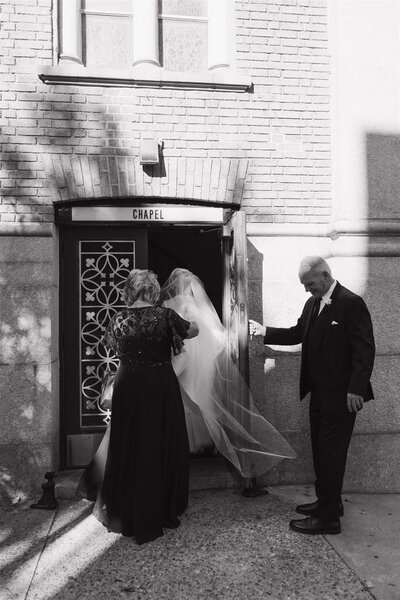 bride entering the church with parents at documentary style wedding in Philadelphia 