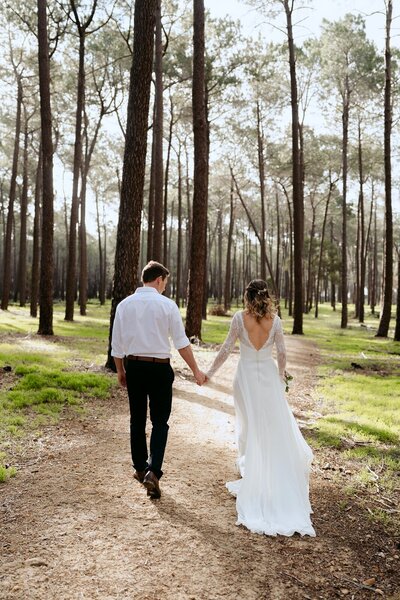 A bride and groom at an elopement in a forest