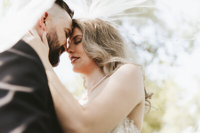 bride holding her dress and bouquet