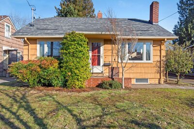 The front of a bungalow house with shake siding.