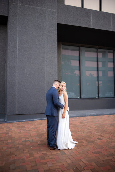 urban groom kissing bride's neck
