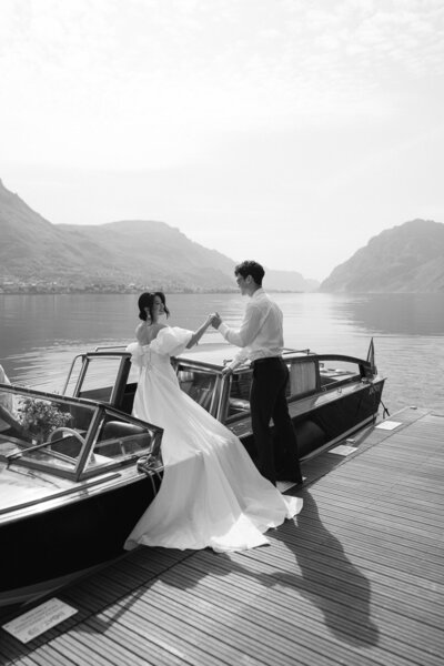 a man helping his bride get out of a boat