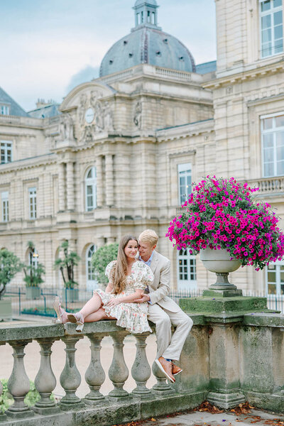 Woman leading into man at Luxembourg Gardens  in Latin Quarter during couples shoot in Paris