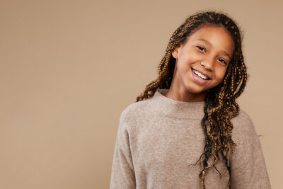 girl smiling with her head tilted