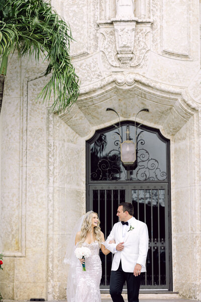 Luxury Miami church wedding with a joyful bride and groom exiting the venue, captured by Rodrigo Varela Photography