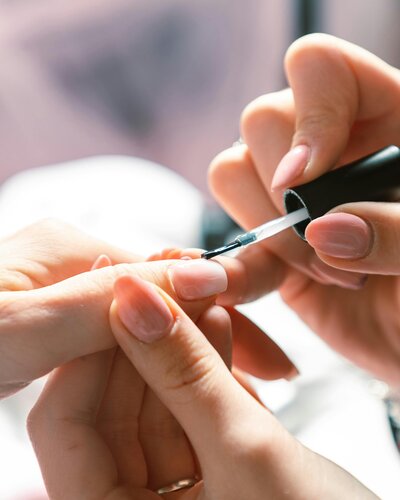 A nail tech sculpts a nail in a private nail salon