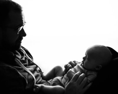 silhouette of father and newborn