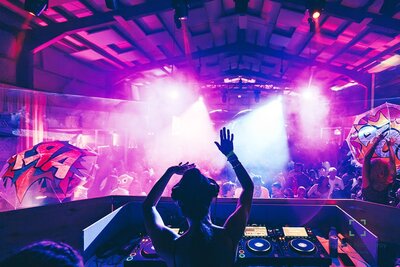 DJ performing at warehouse rave