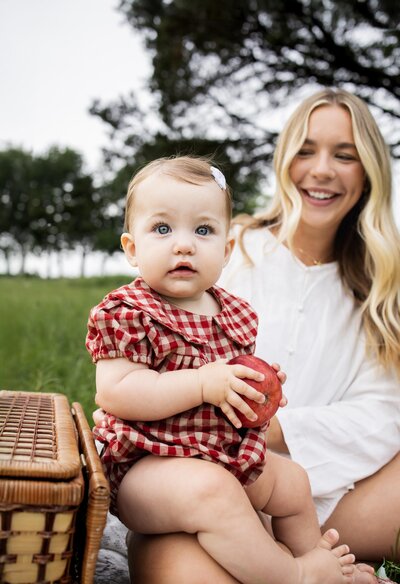 mother holds baby girl at a session in Mckinney Texas.