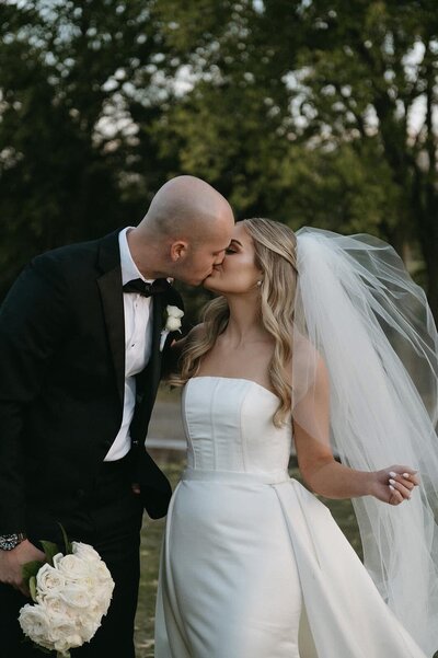 Intimate moment between bride and groom kissing, captured by destination wedding photographer