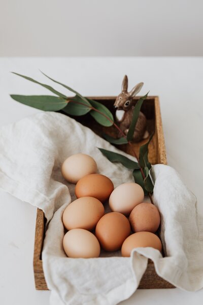 brown-eggs-and-ceramic-bunny-on-a-wooden-tray-4226900