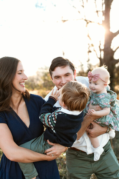 Ashley Hodges takes photo of beautiful family playing together in a field 