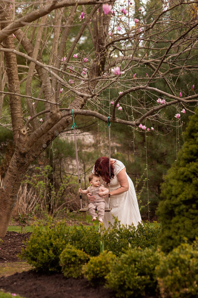 Mom pushes her son on the swing at the Paris House in Long Valley