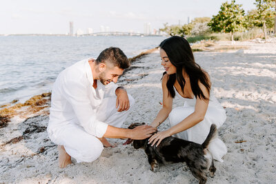 Couple petting dog on Hobie beach.