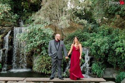 Engaged couple cuddle up and kiss on the outdoor stairs at Rancho Las Lomas