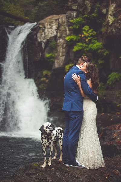 Bride and groom with their dog at a Vancouver Island waterfall