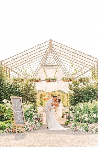 bride and groom kissing outside Floralis Farms wedding venue