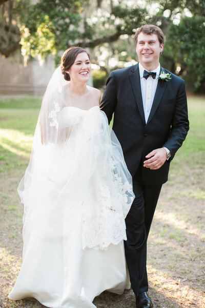 Bald Head Island Bride and Groom walk with photographer after wedding ceremony