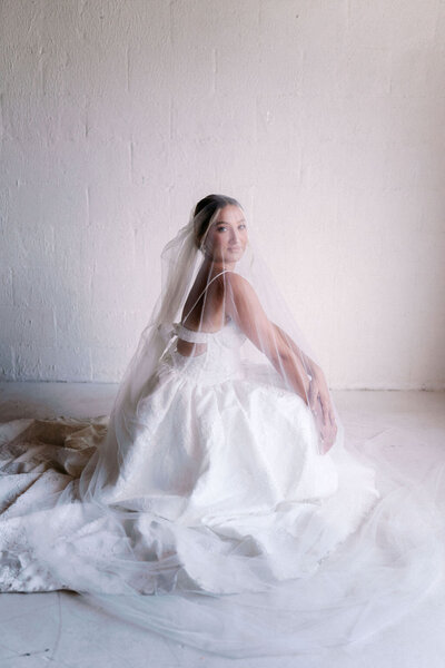 bride in wedding gown sits in the highlight studio in knoxville tennessee