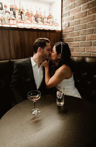 Couple Sitting in Dimly Lit Booth in Bar