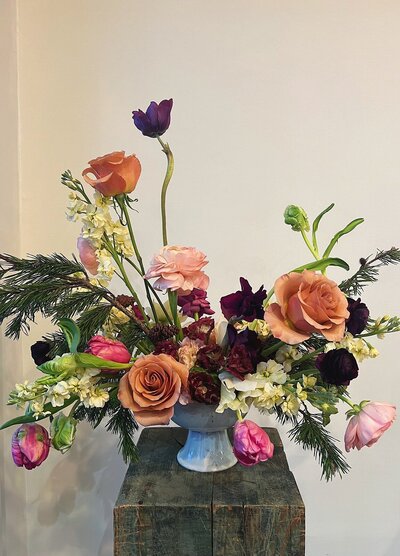 Artistic floral arrangement with roses.